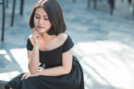 Glamorous chinese babe posing in her elegant ebony dress in public