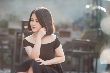 Glamorous chinese babe posing in her elegant ebony dress in public