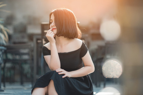 Glamorous chinese babe posing in her elegant ebony dress in public