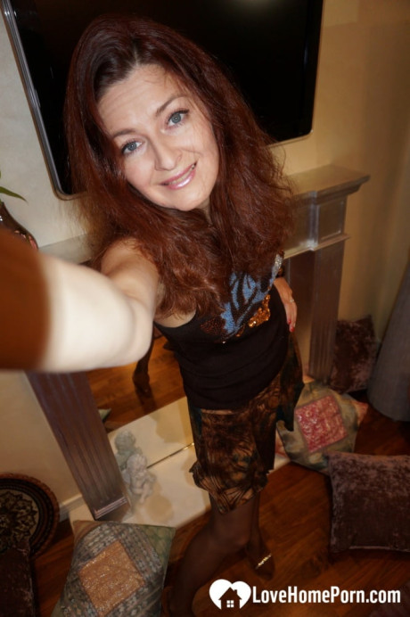Nasty redheaded amateur MILF stripping and posing to take pretty selfies