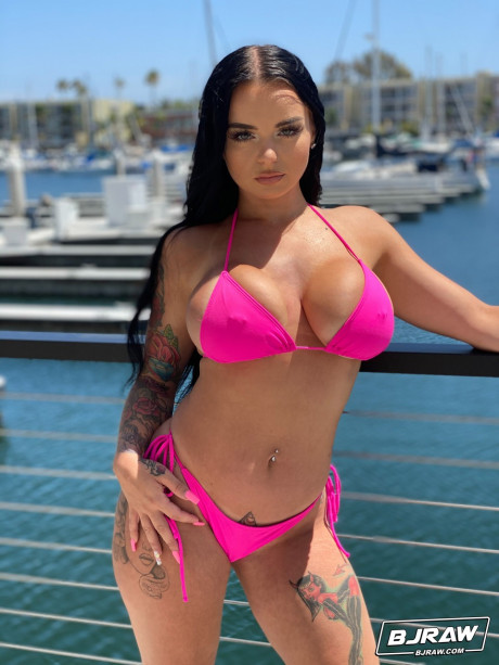 Curvaceous stunner Payton Preslee flaunting her large melons in a pink bikini