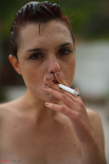 Solo slut girl chick with short red hair and freckles puffs on a smoke after getting wet