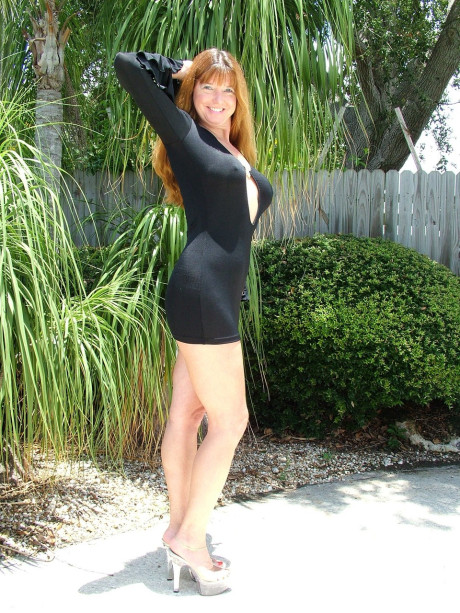 Redheaded old Dee Siren tries out different clothing combinations outdoors