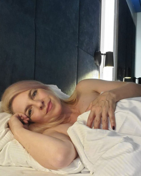 Glamorous blondie amateur teases with her enormous tits on her bed