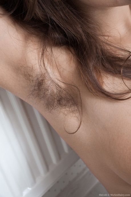 Brunette solo slut gf woman shows off her unshaven armpits and pussy in her bedroom