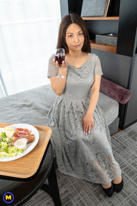 Sweet MILF Midori Minami strips naked and poses enticingly in a hotel room