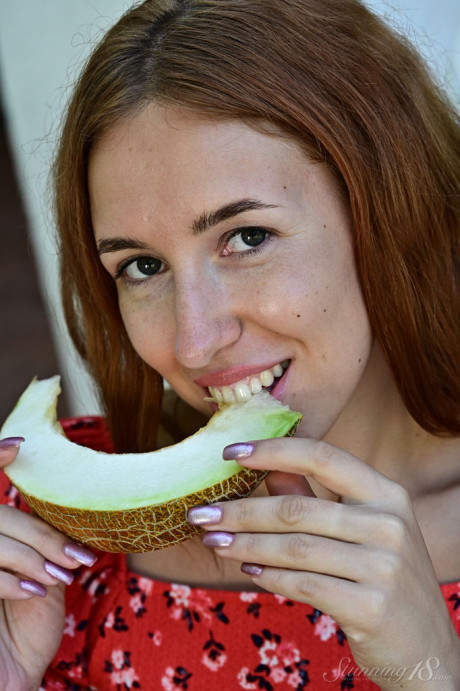 Barely legal ginger Adele eats a melon while getting totally naked