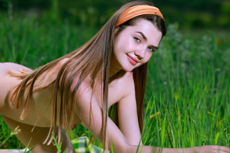 Nice teenie gets nude on a blanket while playing soccer in a field