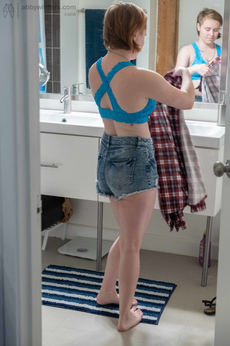 Attractive teen with small boobs Annika gets spied on while dressing in the toilet