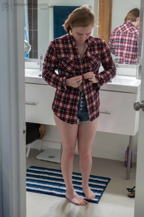 Attractive teen with small boobs Annika gets spied on while dressing in the toilet
