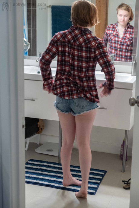 Attractive teen with small boobs Annika gets spied on while dressing in the toilet