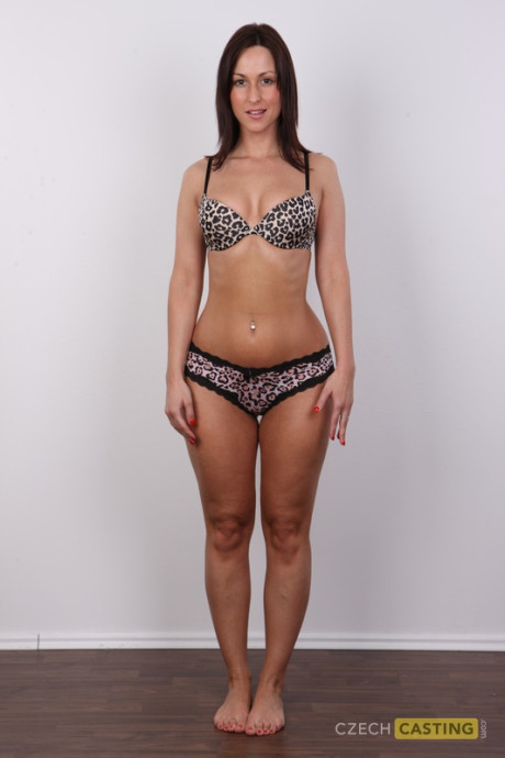 Amateur model with brunette hair stands straight and firm after getting nude