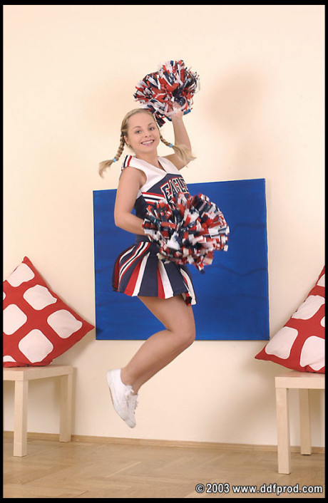 Adorable cheerleader Sharka Blue slides a thick sex toy in her asshole