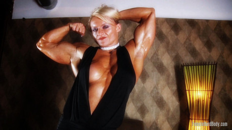 Yellow-haired Slovenian bodybuilder Brigita Brezovac shows her cleavage & hot muscles