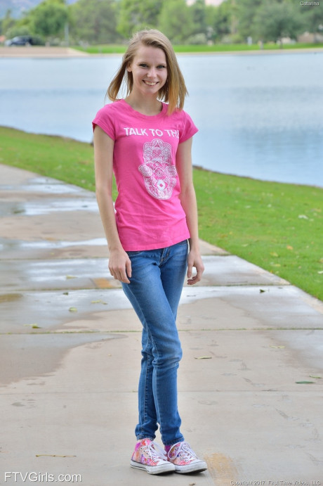 Cute petite young Catarina unveils her tiny boobies and lovely clam at the park