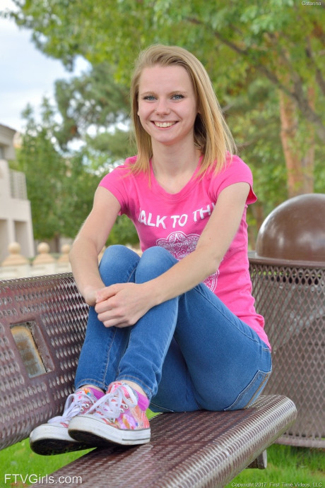 Cute petite young Catarina unveils her tiny boobies and lovely clam at the park