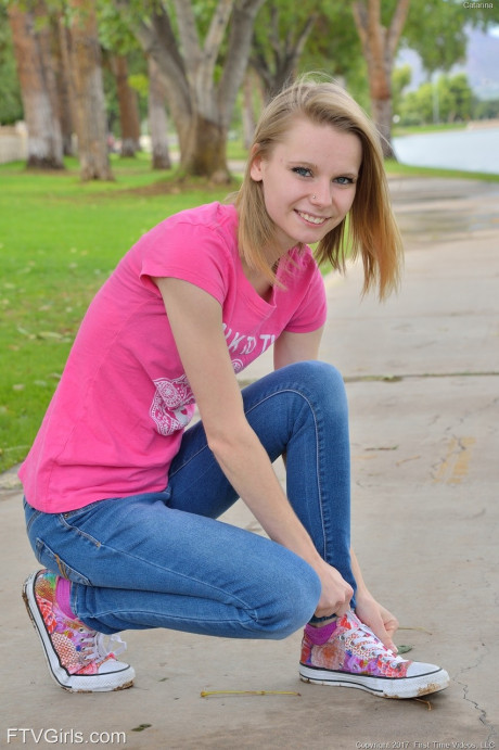 Cute petite young Catarina unveils her tiny boobies and lovely clam at the park