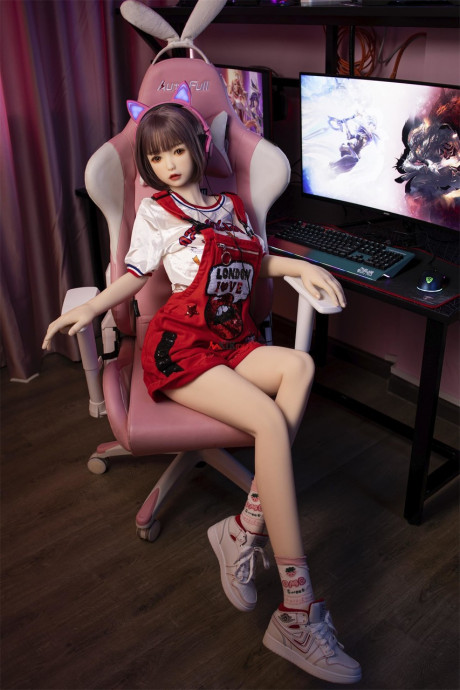 Brunette gamer sex doll Kumi poses undressed and touches her fuckable cunt