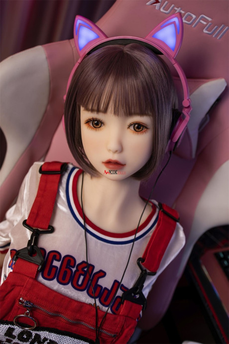 Brunette gamer sex doll Kumi poses undressed and touches her fuckable cunt