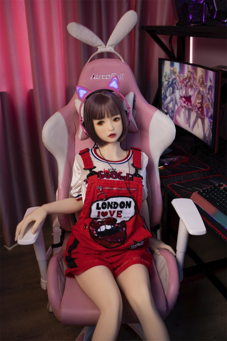 Brunette gamer sex doll Kumi poses undressed and touches her fuckable cunt