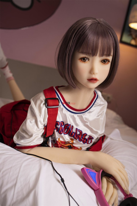 Brunette gamer sex doll Kumi poses undressed and touches her fuckable cunt