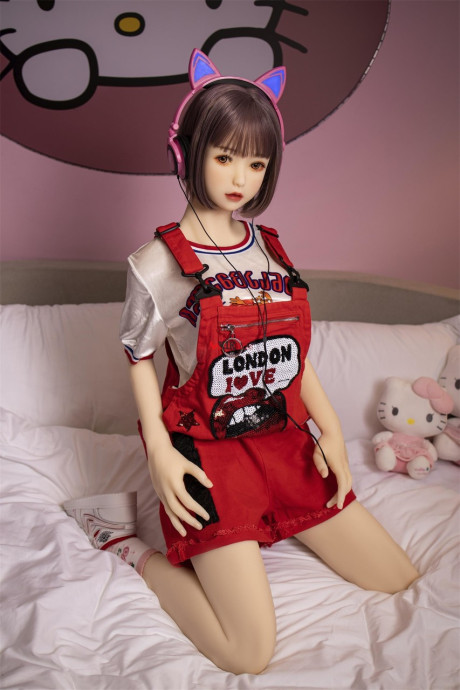 Brunette gamer sex doll Kumi poses undressed and touches her fuckable cunt