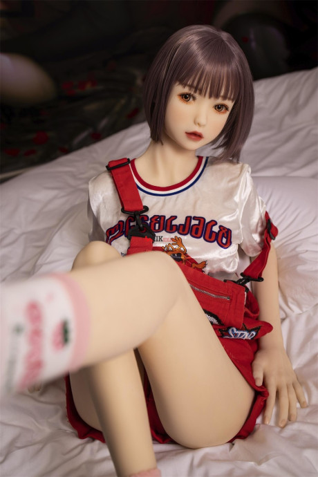 Brunette gamer sex doll Kumi poses undressed and touches her fuckable cunt