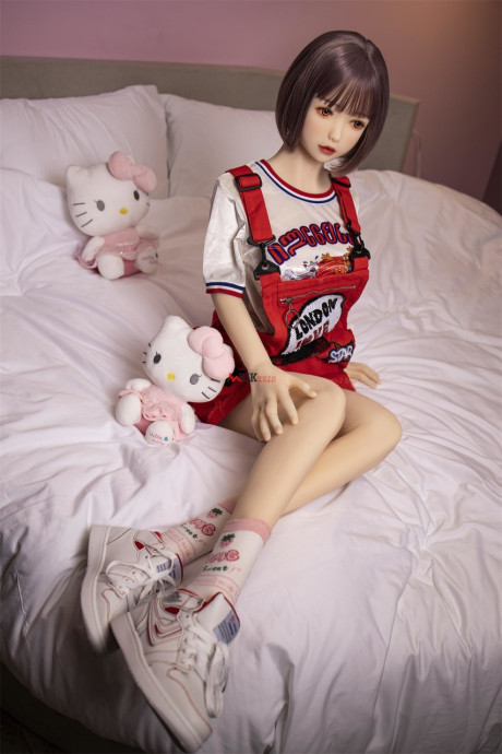 Brunette gamer sex doll Kumi poses undressed and touches her fuckable cunt
