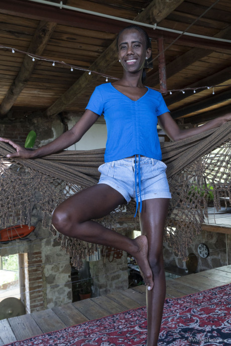 Thin ebony babe Luz M flaunts her small titties during a pretty striptease