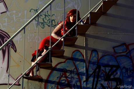 Goth slut gf chick Vanessa Lake peels off red latex dress on stairs of chemical tank