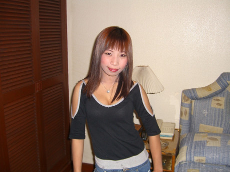 Chinese ginger head strips down to her sandals on top of a motel room bed