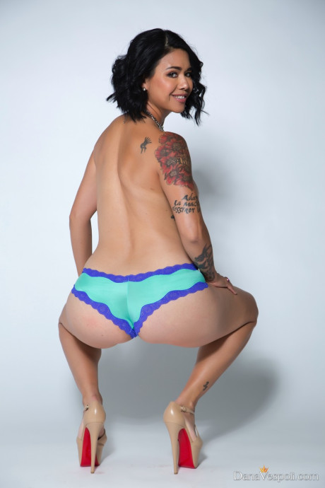 Lovely oriental MILF Dana Vespoli strips to her heels & displays her hot inked body