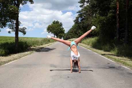 Hot teen Sabrisse does a handstand on the road before getting naked in a field