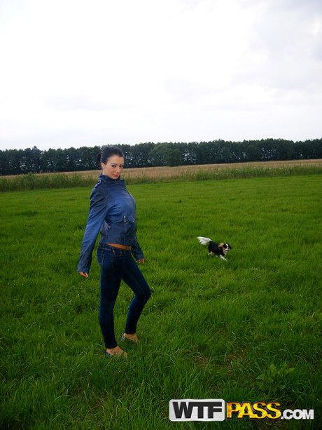 Dark haired chick girl chick Ella shows her firm boobs on a bed and in a field as well
