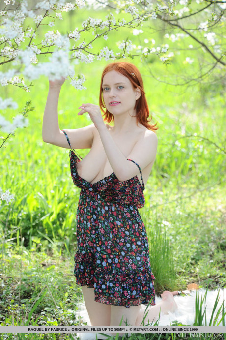 Pale ginger Raquel gets totally undressed underneath a flowering tree