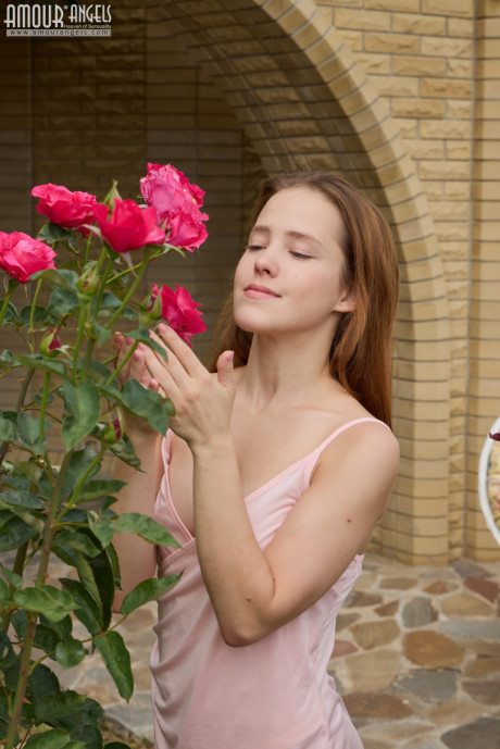Flexible young Nicole sniffs some roses before getting totally nude