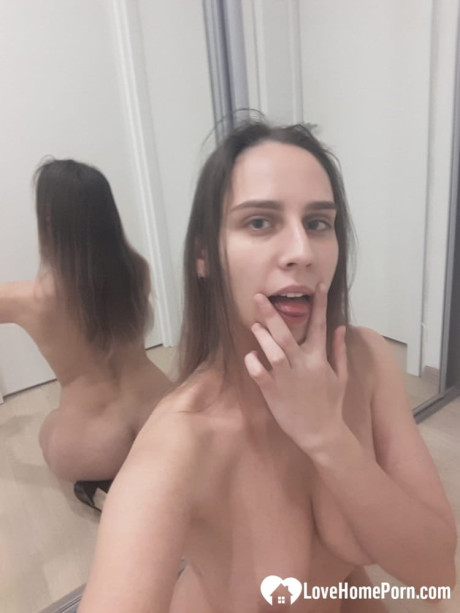 Sleazy amateur babe poses nude in the mirror and shows her juicy boobs