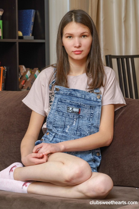 Gorgeous cute teenie babe Mellissa gently fingers her yummy snatch on the sofa