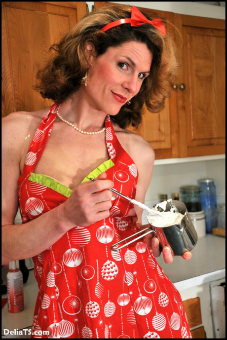Delia frosts her cupcakes in heels, pantyhose and pin up apron