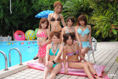 Pretty Japanese girlfriends in lovely swimsuits flaunt their beauty poolside