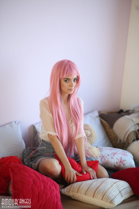 Young sweetheart with a long pink hair gets undressed and flashes her pretty