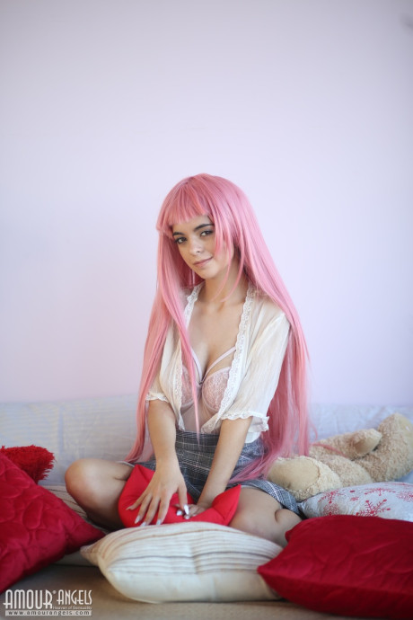 Young sweetheart with a long pink hair gets undressed and flashes her pretty