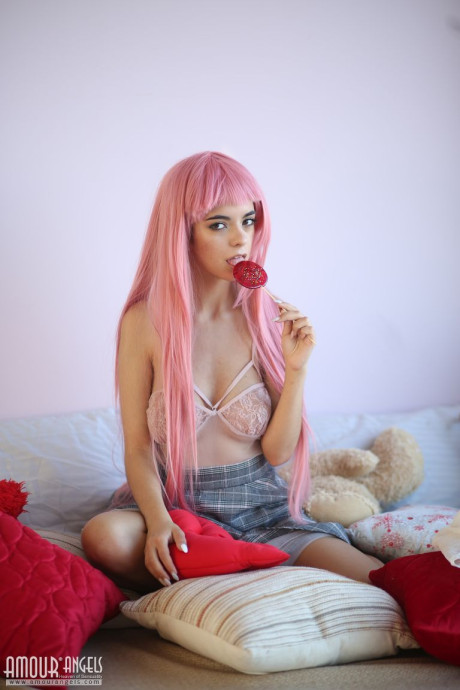 Young sweetheart with a long pink hair gets undressed and flashes her pretty