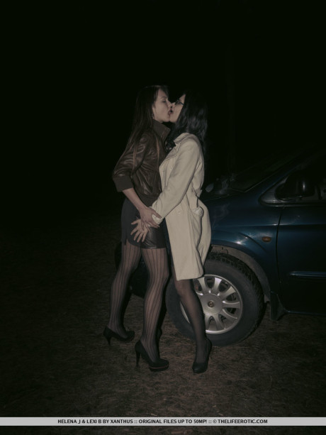 Lesbian lovers Helena J & Lexi B have sex inside of a car at night