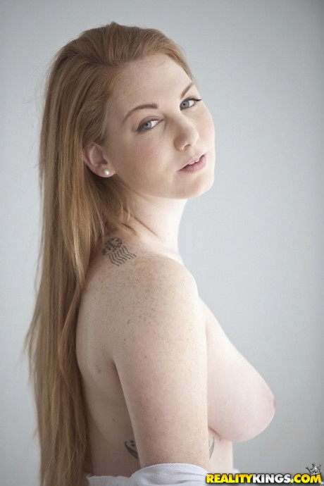Pale ginger head Bre Pheonix uncovers her nice breasts before pinching her nipples