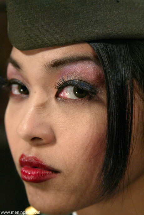 Oriental general Mika Tan disciplines a soldier and grabs his rod