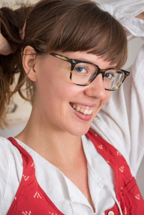 Nerdy female takes a brush to her natural twat after getting undressed