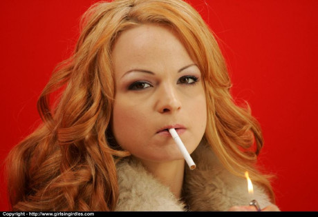 Smoking red hair babe in pantyhose flashing her boobies and twat