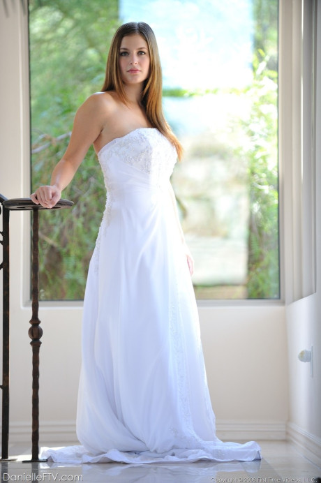 Busty glamorous amateur Danielle models wedding gown indoors & by the pool