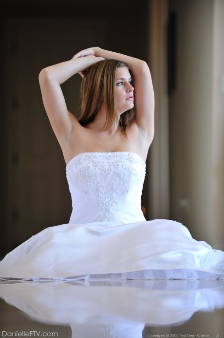 Busty glamorous amateur Danielle models wedding gown indoors & by the pool